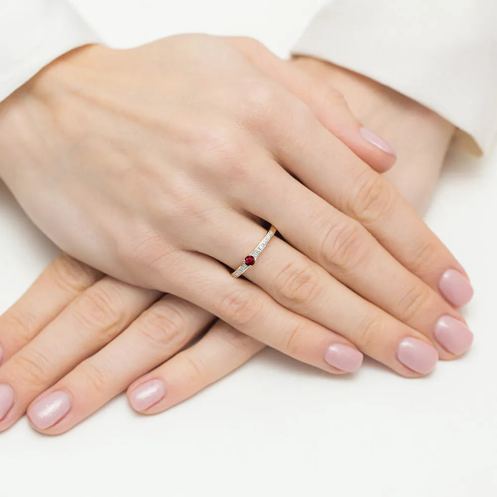 14-karätiger Goldring mit 0,15 ct Rubin und 0,05 ct Diamanten. Verpackt in schwarzer Schachtel, Papier und Geschenktüte.