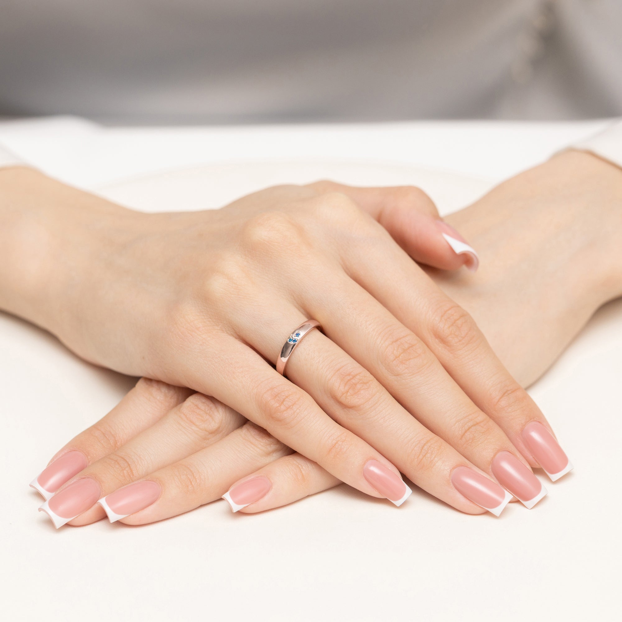 14k rose gold ring with 2 blue zirconia hearts. Classic design with modern twist. Packed in black box, paper, and gift bag.