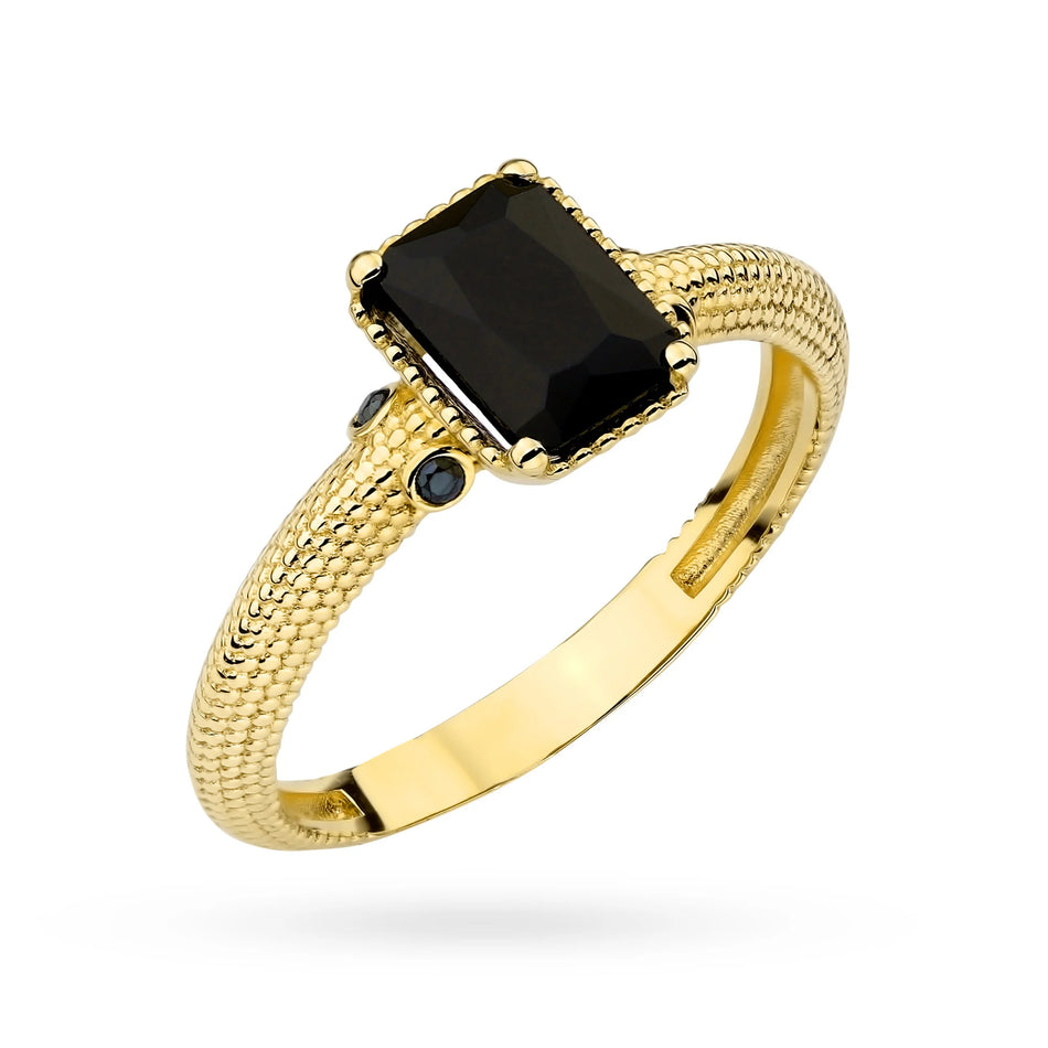 Decorated gold ring with black stone