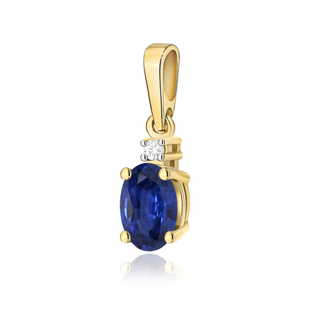 Gold pendant with oval sapphire and additional diamonds.